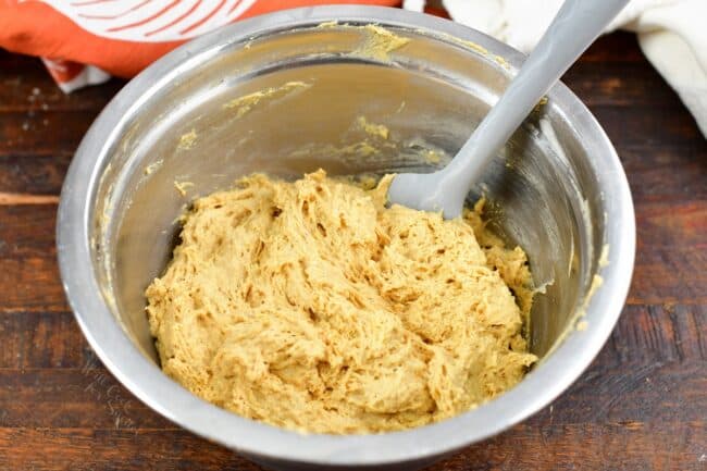 mixed batter in a bowl for the pumpkin donuts