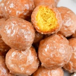 closeup of pumpkin doughnuts with one bite taken out