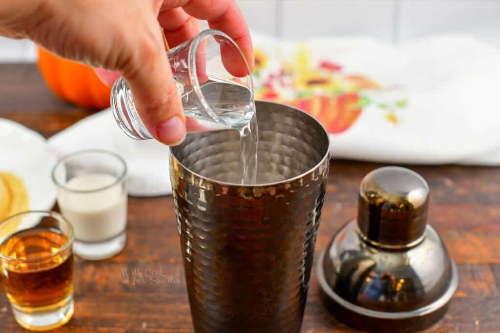 adding vodka to the cocktail shaker