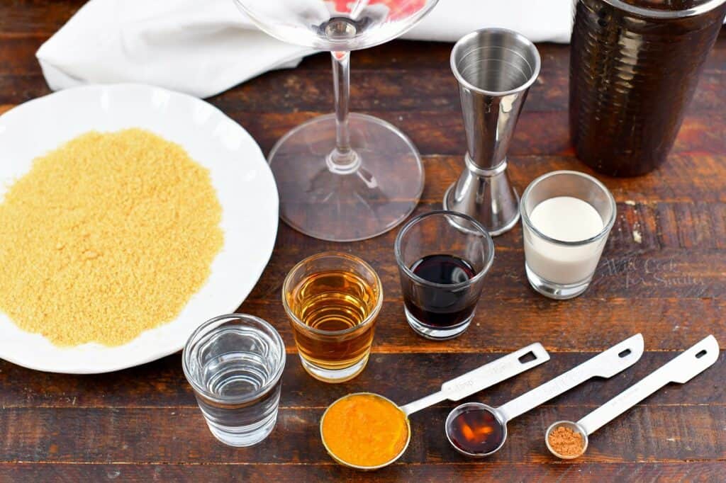 ingredients for the pumpkin pie martini on a wooden board