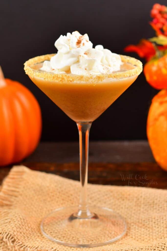 tall martini glass with pumpkin pie martini and whipped cream