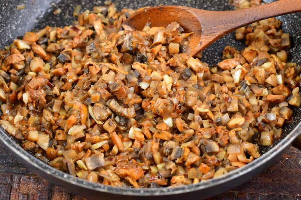 mushrooms cooked in a pan with a spoon
