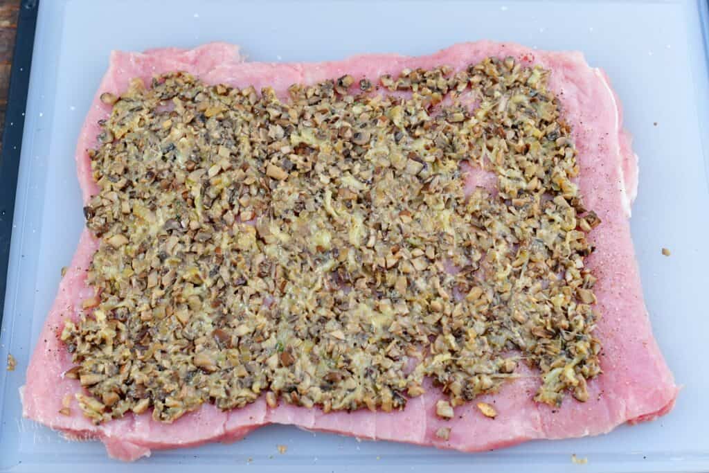 stuffing spread all over the pork loin