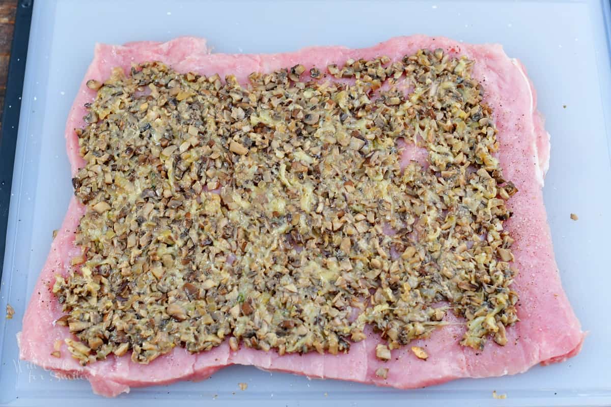 stuffing spread all over the pork loin