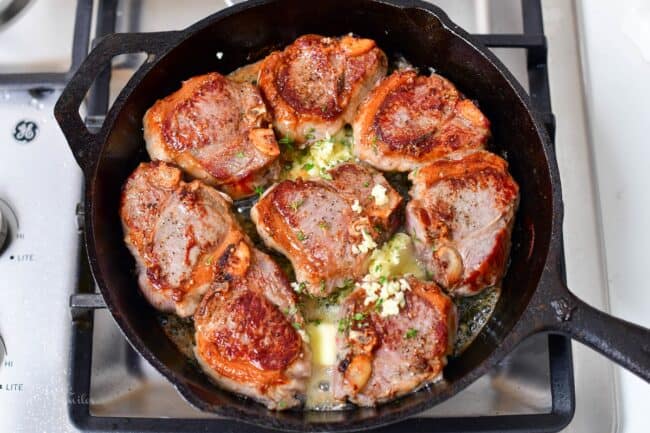 searing the chops with butter and garlic added in the pan