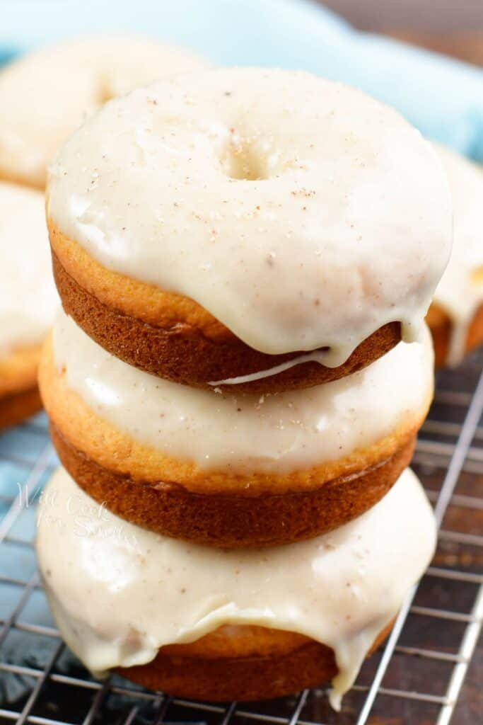 stacked glazed donuts on a wire rack