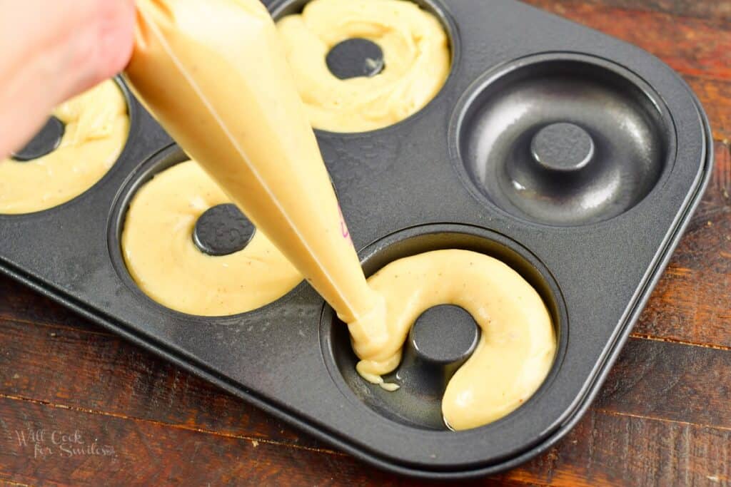 adding batter to the donut pan