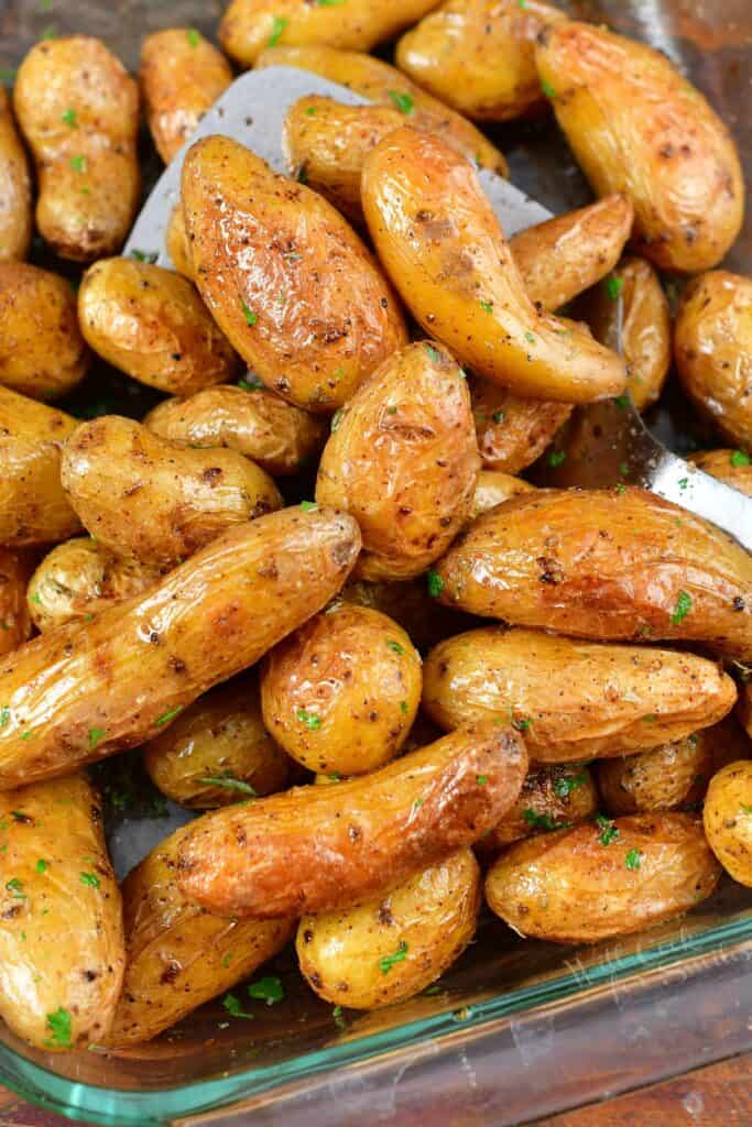 closeup of roasted fingerling potatoes with spatula