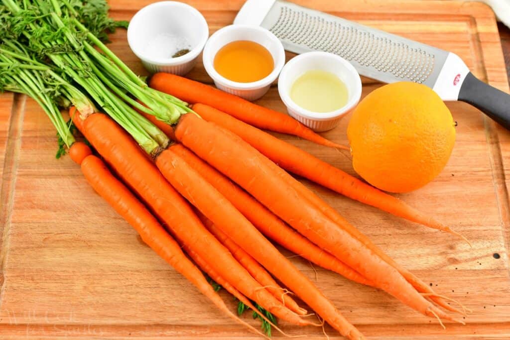 ingredients for honey roasted carrots on a cutting boad