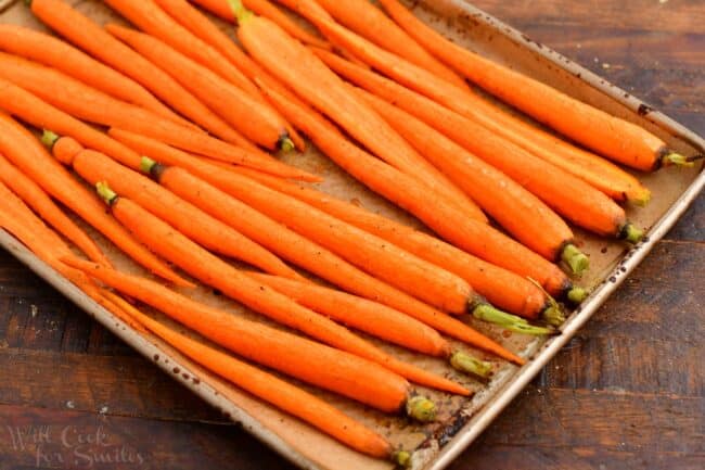 roasted carrots on a gold baking sheet