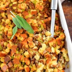 top view of sausage stuffing in a dish with a serving spoon