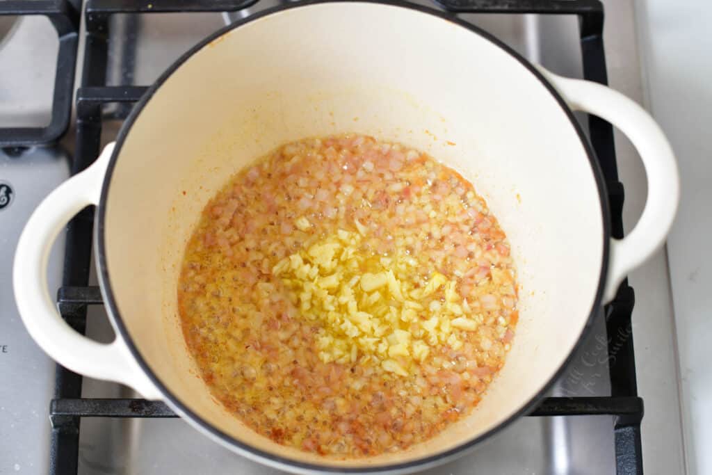 sautéing shallots and garlic in a white pot