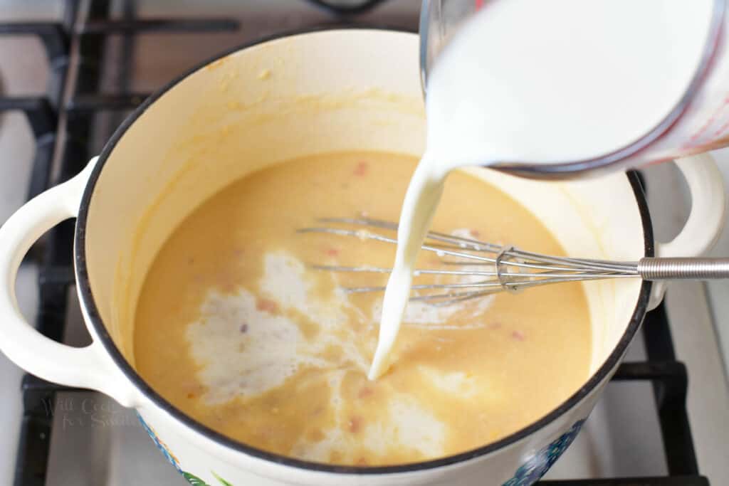 adding whole milk to the pot