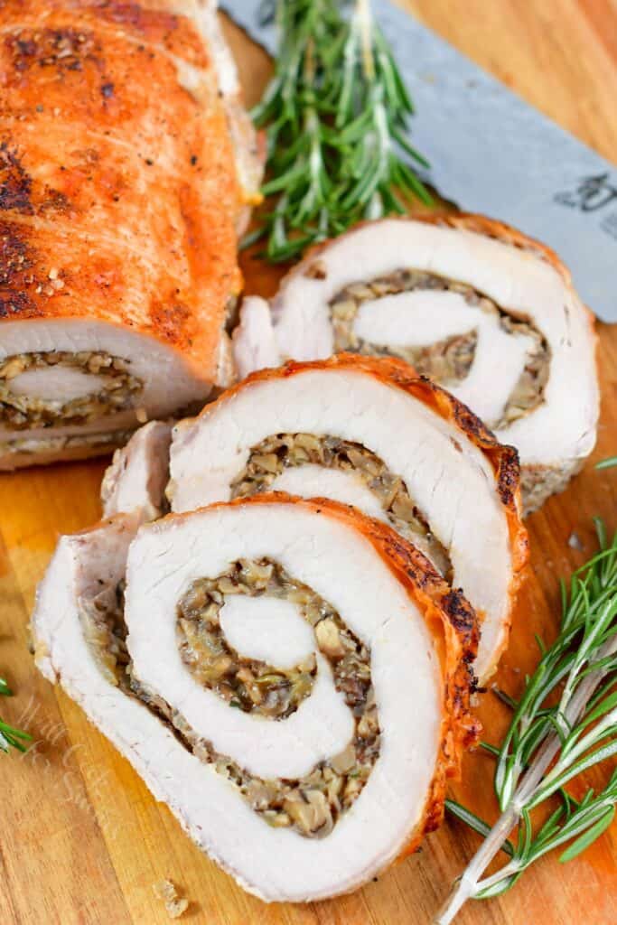 three slices of stuffed pork loin on the board