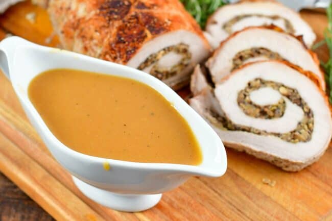 gravy for pork loin next to sliced pork loin