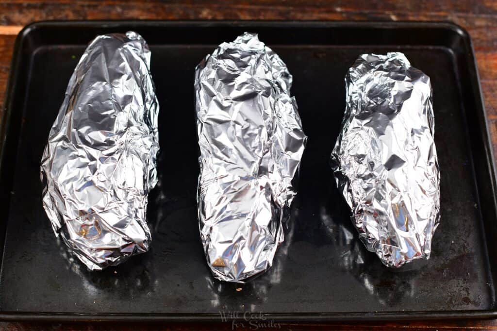 sweet potatoes tightly covered in foil