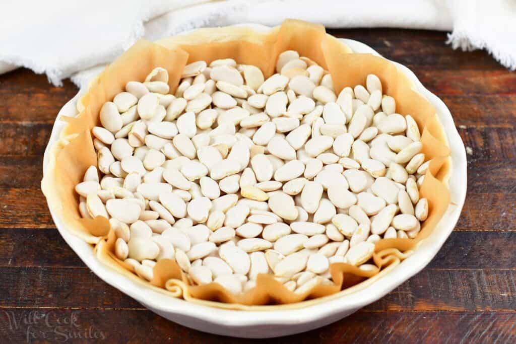 beans inside the pie dish over the pie crust