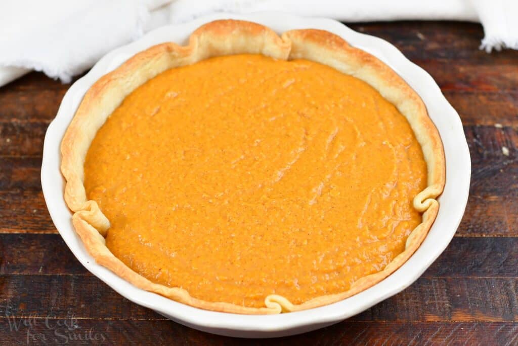unbaked sweet potato pie on the wood board