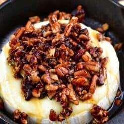 top view of baked brie topped with honey and pecans