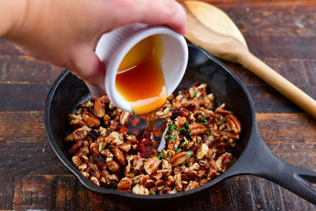 adding honey to toasted pecans and rosemary