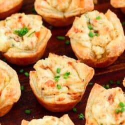 closeup of a few crab puffs on a wooden plate