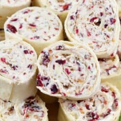 closeup of rolled cream cheese pinwheels with cranberries and brie