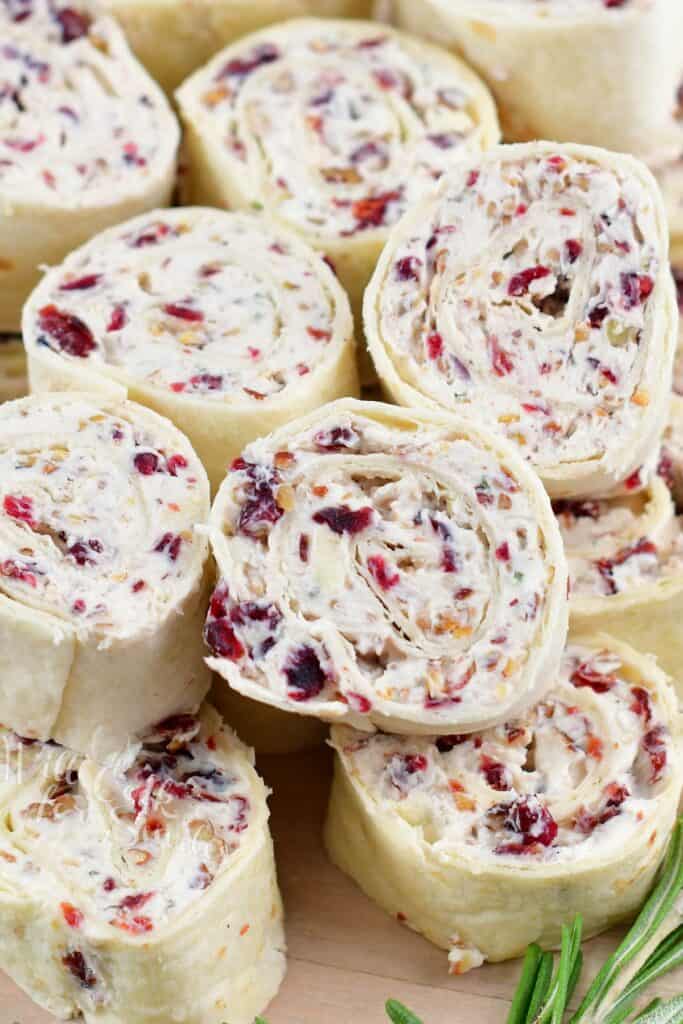 closeup of rolled cream cheese pinwheels with cranberries and brie