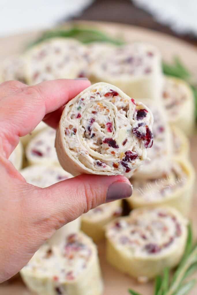 holding one cream cheese pinwheel