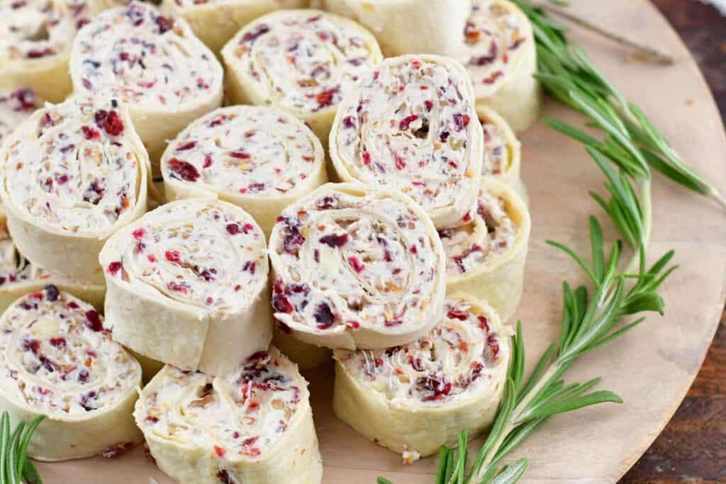 closeup of cream cheese pinwheels with rosemary sprigs