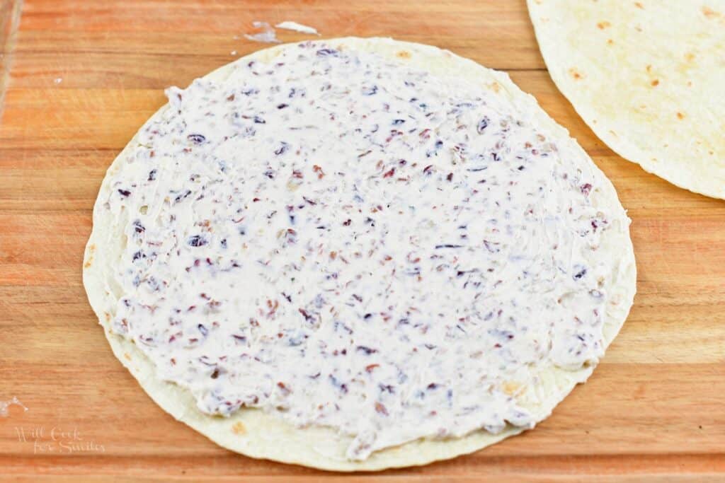 cranberry cream cheese mixture spread in a large tortilla