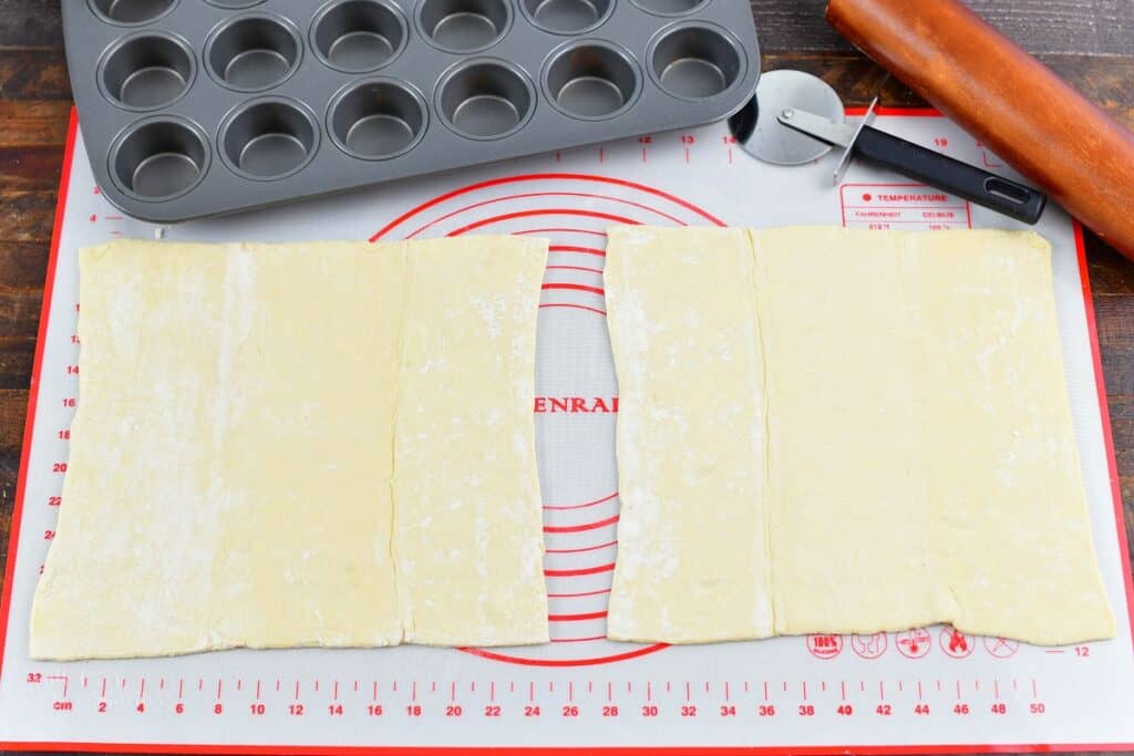 two sheets of puff pastry a rolling pin and pizza cutter