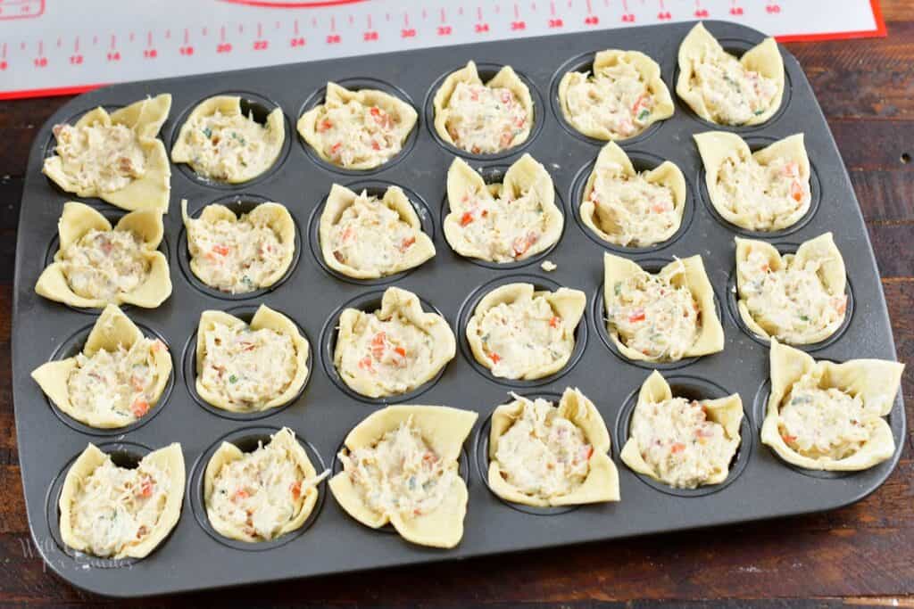 puff pastries stuffed with crab filling in a muffin pan