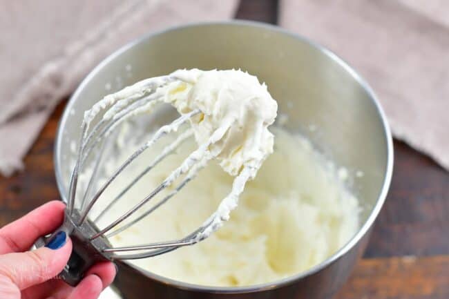 whipped frosting on a whisk attachment