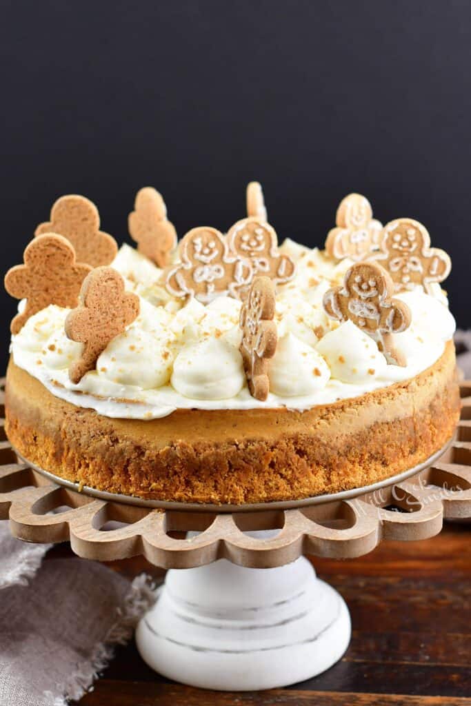 side view of the gingerbread cheesecake on a cake stand