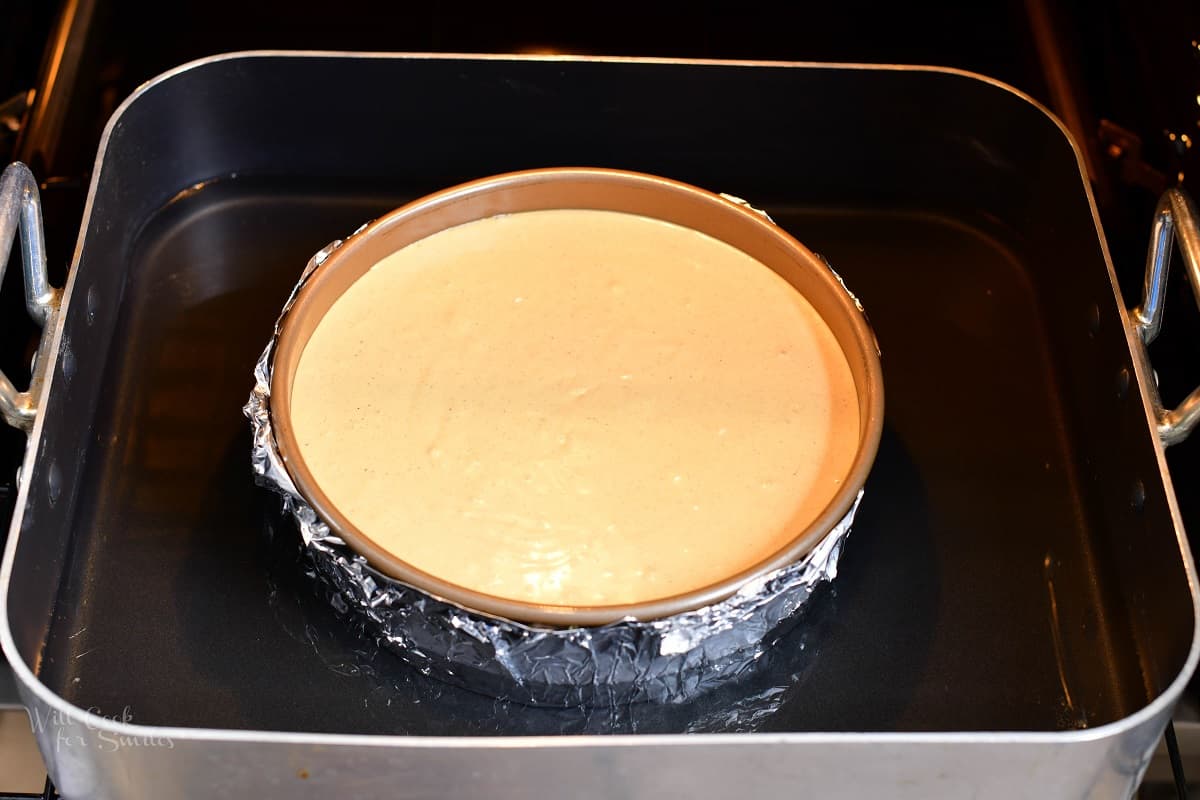 cheesecake pan surrounded by water in a roasting pan