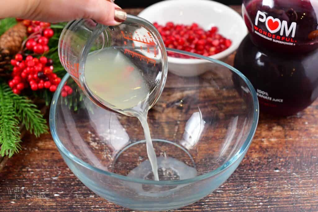 adding lime juice to the punch bowl