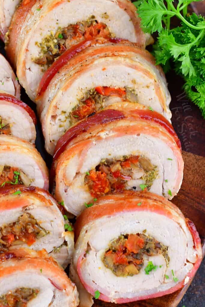 closeup of sliced stuffed pork tenderloin on a platter