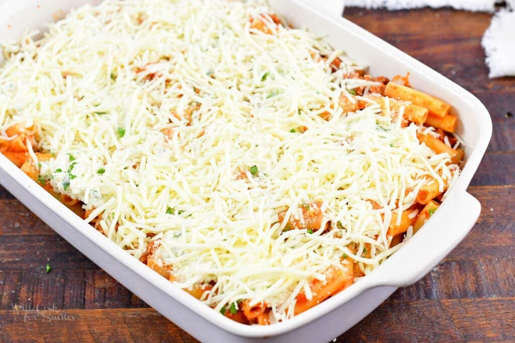 baked ziti layered before baking in a baking dish