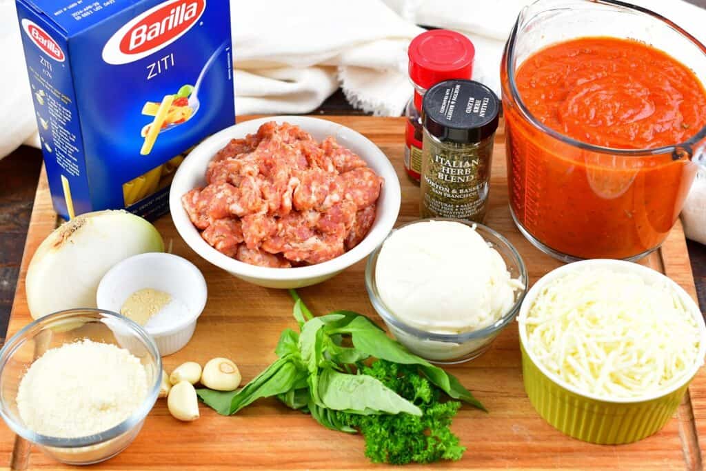 ingredients for baked ziti on a cutting board
