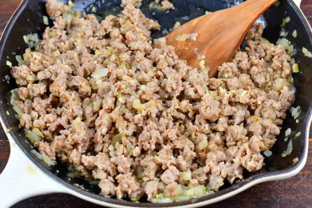cooked Italian sausage with onions and garlic in a cooking pan