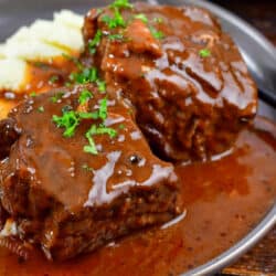 closeup boneless short ribs with sauce and mashed potatoes