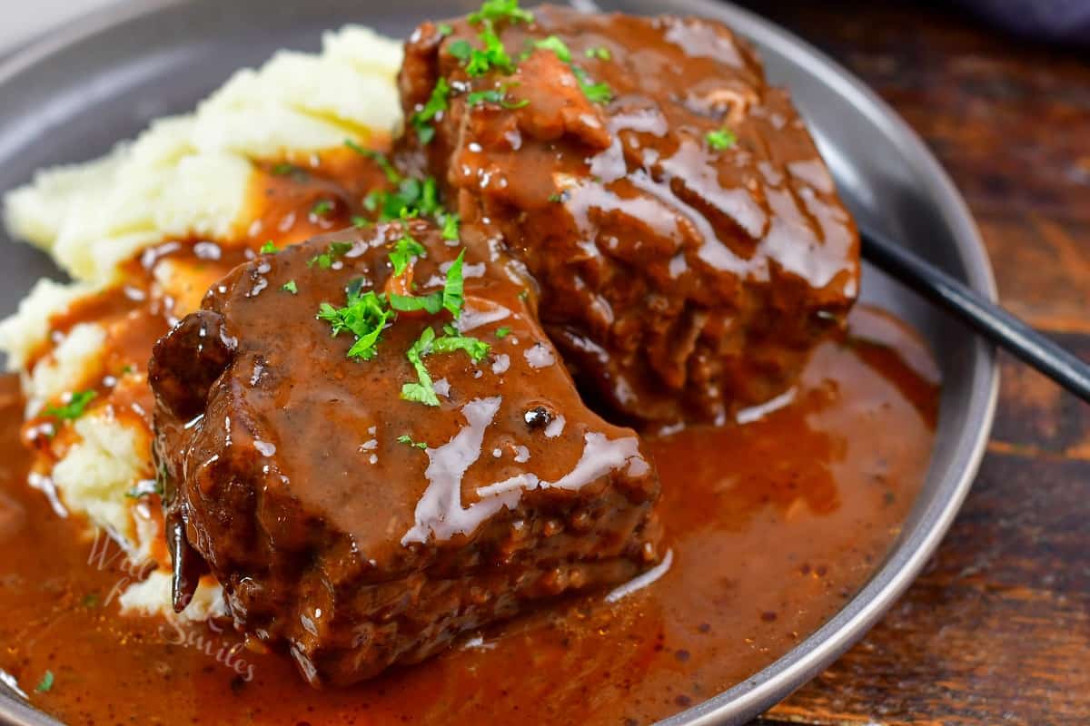 closeup boneless short ribs with sauce and mashed potatoes