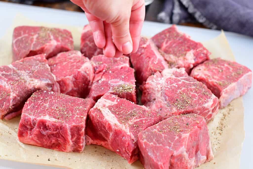 seasoning short ribs with salt and pepper