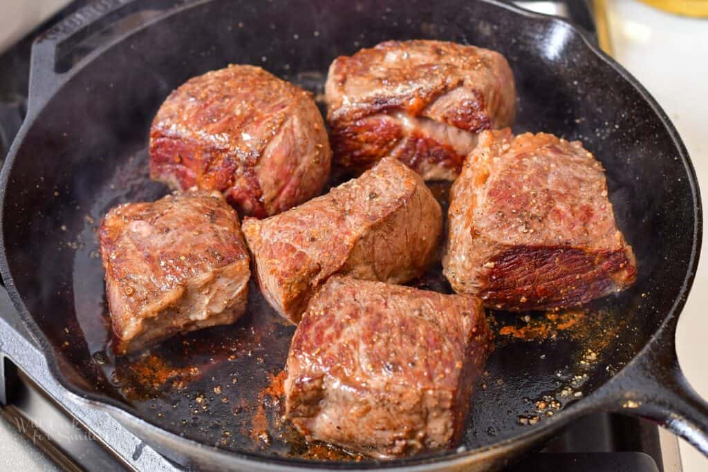 searing boneless short ribs in a skillet