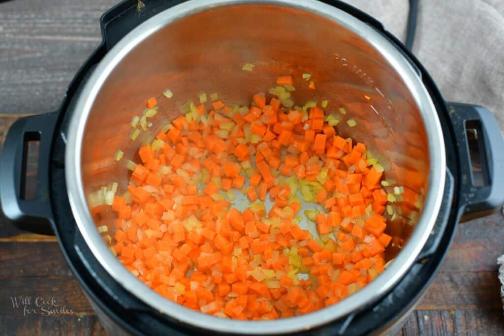 sauteed onions and carrots in the pot