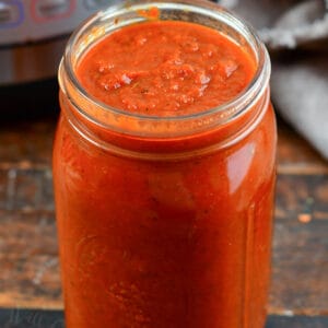 pasta sauce in a glass jar next to Instant Pot