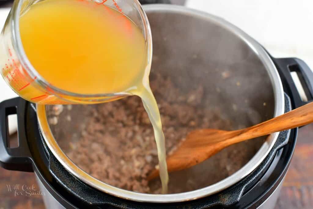 pouting in chicken stock into the meat mixture