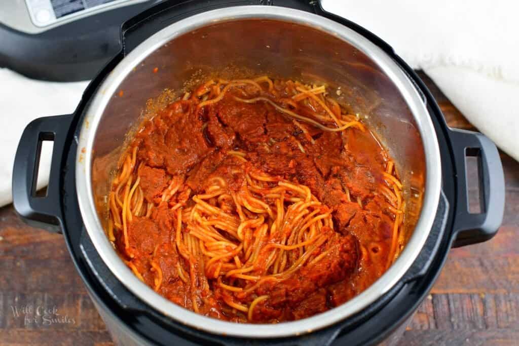 cooked pasta with sauce after opening the pot lid