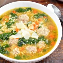 closeup of Italian wedding soup topped with shaved Parmesan