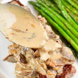 spreading sauce over mushroom sauce topped steak